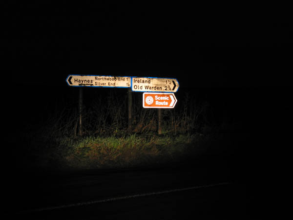 [PHOTO: nighttime view of signposts: 17kB]