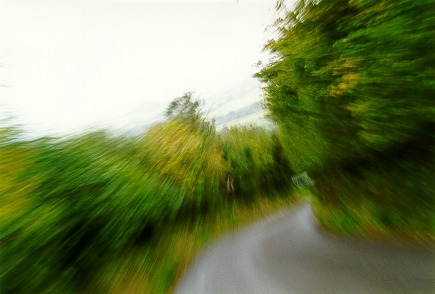 [PHOTO: downhill bend, blurred for impression of speed: 34kB]