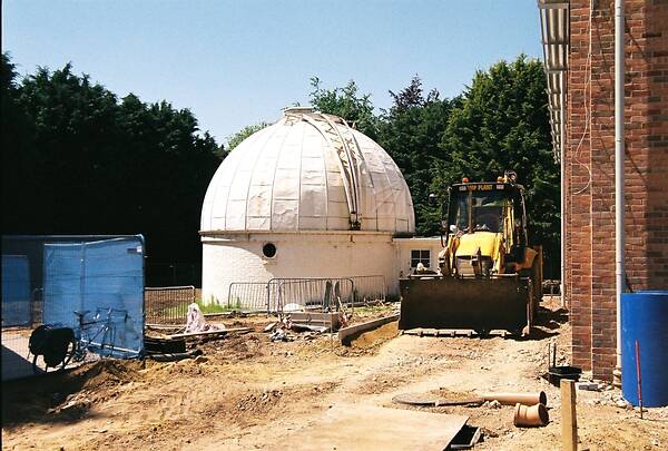 [PHOTO: A bulldozer on a building-site beside the 36-inch dome: 57kB]