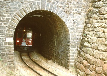 [PHOTO: Swiss mountain-railway train emerging from tunnel: 49kB]